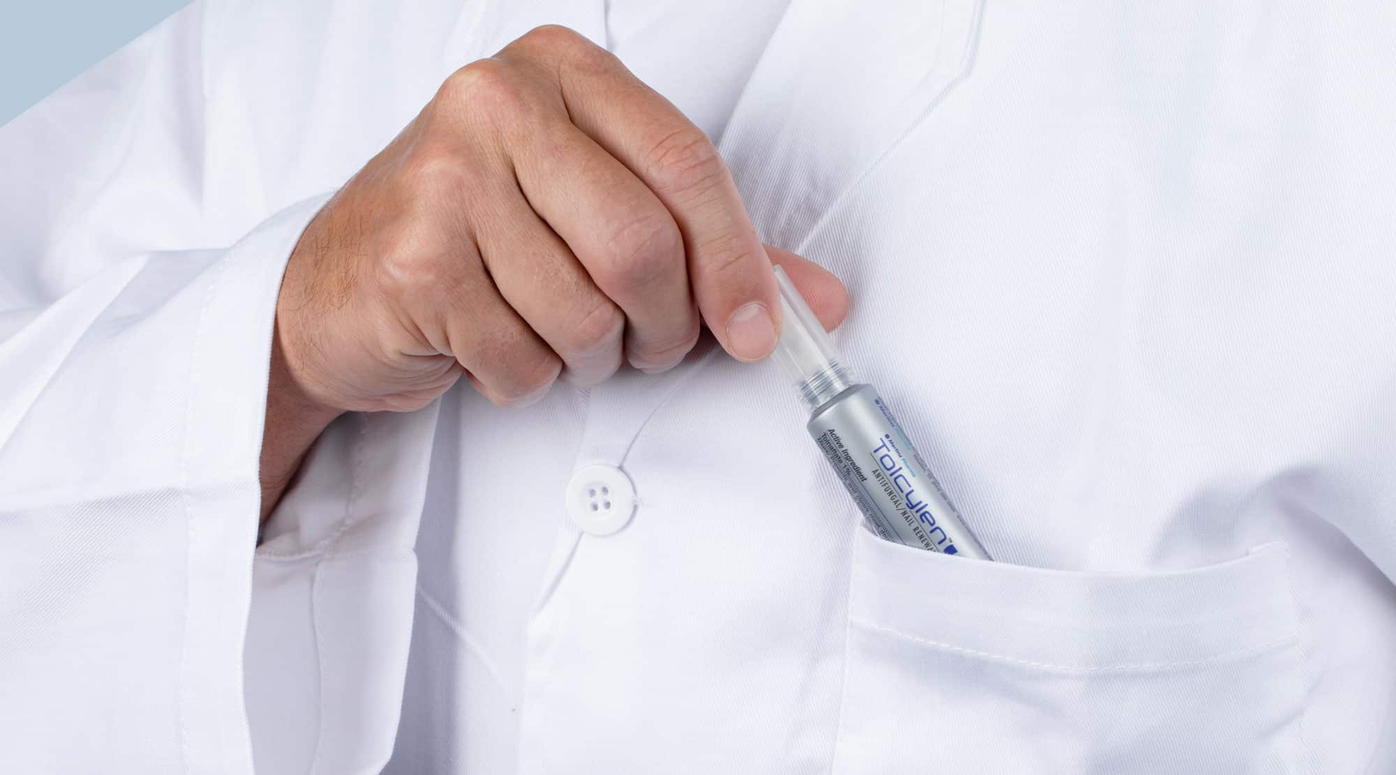 Person wearing a white lab coat putting a small tube in the pocket.
