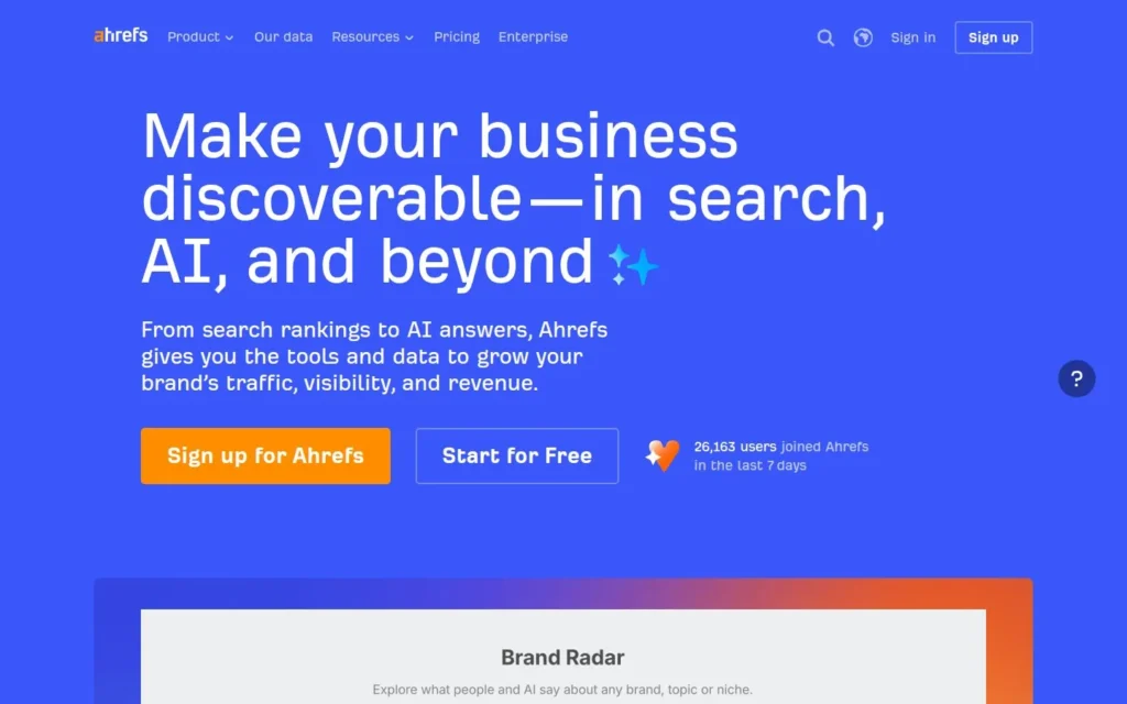 Ahrefs homepage with the headline “Make your business discoverable—in search, AI, and beyond” on a blue background.
