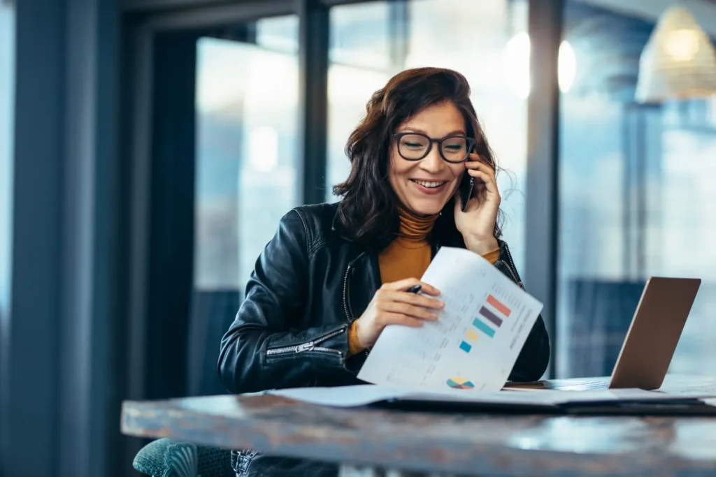 a business woman happy with the monthly reports - Digitech