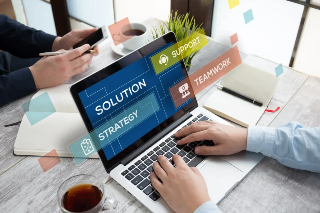 a laptop that says solution strategy teamwork and support on the screen - Digitech
