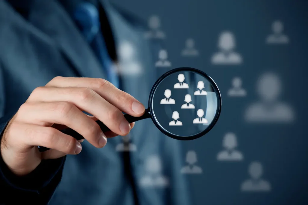 a man holding a magnifying glass over target audience icons - digitech