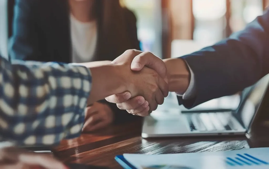 two hands shaking over a business deal - Digitech Austin
